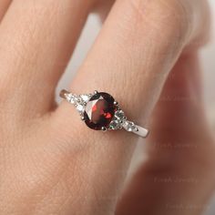 * The delicate ring displays Garnet as main stone. The cluster side stones make the ring similar to the blooming flower . For who wearing this special & delicate ring, will shine like a goddess. ◆ Production Description: Main stone Type: Garnet Main Stone Shape: Oval Cut Main Stone Size: 6*8mm(1.73ct) Side stone: CZ Metal: 925 Sterling silver - Other options available in the drop down menu ◆ Customization: √Free for Add Engraving √Other Metal Type Available √Other Gemstones & Shapes Avai Garnet Ring With Prong Setting, Delicate Oval Ring With Center Stone, Oval Crystal Promise Ring In Fine Jewelry Style, Fine Jewelry Crystal Ring With Accent Stones For Proposal, Elegant Garnet Jewelry For Proposal, Oval Flower Ring For Wedding, Elegant Oval Garnet Birthstone Ring, Elegant Round Garnet Crystal Ring, Elegant Garnet Crystal Round Ring