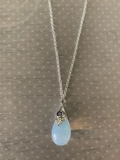 "Lovely moonstone white teardrop shaped necklace featuring silver tone regal motif with purple inlaid gem stone. Pendant measures 7/8\" L X 1/2\" W and is on an 18\" chain. Note: This is a slightly smaller version of this necklace sold prior to 6/30/20. Also available with a black stone under the following listing: https://www.etsy.com/listing/858843851/moonstone-necklace-moon-stone-necklace?ref=listings_manager_grid ★ Want to see more? Please visit my shop at: https://www.etsy.com/shop/DesignsB Purple Gemstone Necklace, Moonstone Necklace Pendants, Moonstone Aesthetic, Moon Stone Jewelry, Moon Stone Necklace, Gem Stone Pendant, Gem Stone Necklace, Purple Stone Necklace, Purple Pendant