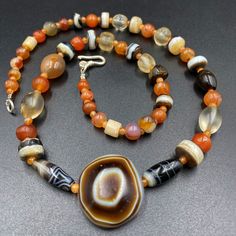 The beautiful mala necklace consist of Himalayan luk Mik or we called them magic eye bead as well in the center of the mala necklace with Banded Agate and carnelian and crystals Luk Mik means (Goat's eyes) in Tibetan Natural found from Himalaya Tibet dating more than 1000 yrs. The origin of this beads from Himalaya Tibet but also can found in India, Nepal and Pakistan too They were used as a special charm Jewelry and amulet at that time period very good condition They were used in prayers mala a Round Agate Gemstones For Spiritual Use, Amber Spiritual Natural Gemstones, Round Agate Amulet Necklace, Spiritual Round Agate Beaded Gemstones, Spiritual Agate Round Bead Gemstones, Spiritual Round Agate Bead Gemstones, Carnelian Round Jewelry For Meditation, Round Carnelian Jewelry For Meditation, Handmade Agate Gemstones For Meditation