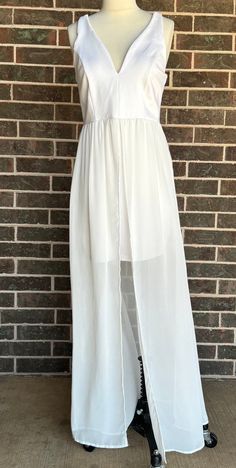 Just in time for summer, you will enjoy this short white dress made out of a thick jersey with white chiffon  long overskirt.  Manufactured by "J for Justify" this dress has a deep V neckline and a square back and closes with a 9" center back zipper.  The label lists it as a large and the body of the dress is made of 95% polyester and 5% spandex, the skirt is 100% polyester. There are some missing stitches on the back straps but everything else appears in intact.  There are not any noticeable st White Lined Maxi Dress, White Lined Skirt Maxi Dress For Spring, White Sleeveless Dress With Flowy Skirt, Summer Maxi Dress With Tulle Skirt, White Sleeveless Flowy Maxi Dress, Sheer Mini Skirt For Summer, White Flowy Sleeveless Dress, Flowy White Chiffon Party Dress, White Flowy Skirt Dress For Spring