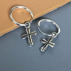 Comes with a detachable cross charm. The charm is multipurpose and can be used with a neck or bracelet chain too. Dimension: Hoop- 12 x 1.2 mm Cross: 7 x 12 mm Weight: 0.70gm Price listed is for a PAIR of hoops. These earrings are made of 925 hypoallergenic sterling silver and comes with a 925 stamp. Can be packaged in a gift box. I can include a personal message from you if needed You are welcome to contact me at... bhavnakwintra1956@gmail.com For more beautiful pieces from my shop, please brow Silver Nickel-free Huggie Hoop Earrings, Nickel-free Silver Dangle Huggie Earrings, Silver Nickel-free Dangle Huggie Earrings, Silver Dangle Huggie Earrings Nickel-free, Nickel Free Small Hoop Huggie Earrings As Gift, Nickel-free Hoop Huggie Earrings As Gift, Nickel-free Small Hoop Huggie Earrings For Gift, Silver Charm Hoop Earrings, Nickel Free Sterling Silver Huggie Hoop Earrings