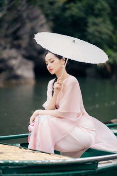 Elevate your style with our Ao Dai. This exquisite garment boasts an A-line silhouette and delicate cut-out detailing crafted from premium organza. Perfect for special occasions, its floor-length design adds drama and elegance. Make a statement and exude luxury with every step. Length: 115cm-115cm-117cm (S/M/L), Pants: 104cm-105cm-105cm (S/M/L) Elegant Spring Ceremony Gown, Organza Gown For Banquet, Organza Dresses For Ceremonies, Spring Wedding Long Gown, Summer Wedding Ao Dai In Maxi Length, Summer Wedding Long Ao Dai, A Line Cut, Mean Blvd, Organza Fabric