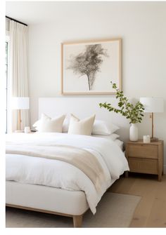 a bed with white linens and pillows in a bedroom next to a painting on the wall