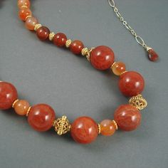 Crackle Agate and Carnelian Necklace is adjustable 17 to 20 inches. Strand of Red Crackle Agate and Tangerine Carnelian is accented with Gold Fill  beads. It closes with a gold fill lobster claw clasp. Red Crackle, Carnelian Necklace, May 11, Fire Opal, Lobster Claw, Gold Filled, Sterling Silver Rings, Agate, Opal