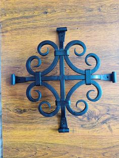 an iron cross on a wooden surface