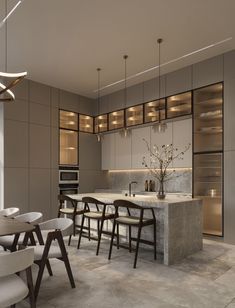 a modern kitchen with marble counter tops and chairs