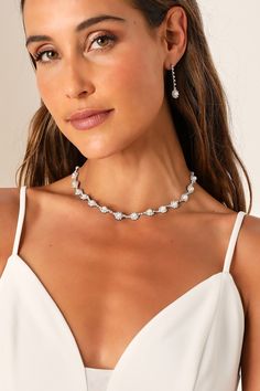 Any occasion that calls for the Lulus Elevated Luxury Silver Rhinestone Pearl Necklace and Earring Set is sure to be a glamorous and memorable event! This stunning jewelry set starts with a dazzling silver necklace that features a series of rhinestone-embellished medallions with shiny faux pearl centers. The matching earrings boast a drop silhouette with slender chains accented with clear rhinestones and the same eye-catching medallions at the ends for a posh finish. Bridesmaid Silver Jewelry, Silver Necklace And Earring Set, Pearl Necklace For Wedding, Makeup For Silver Jewelry, Glamorous Silver Crystal Jewelry Sets, White Gold Crystal Bridal Necklace For Party, Glamorous Sparkling Silver Jewelry Sets, Glamorous Sterling Silver Wedding Necklace, Silver Cubic Zirconia Bridal Necklace For Evening