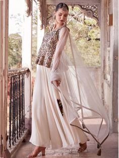 This beautifully crafted set includes an off-white color satin peplum top with intricate print work, a georgette palazzo in a similar off-white shade, and a net dupatta with designer lace work to complete the look. The set is fully stitched and available in M & XL sizes, making it convenient for all body types.
The off-white peplum top palazzo set offers a myriad of benefits to the wearer. The soft georgette fabric ensures comfort and breathability, while the elegant design and intricate det Wedding Sharara With Chikankari Embroidery And Peplum Style, Cream Sharara With Sheer Dupatta For Diwali, Elegant Peplum Palazzo Set For Diwali, Elegant Eid Peplum Set, Elegant Peplum Set For Eid, Cream Anarkali Gown In Georgette, Cream Anarkali Georgette Gown, Elegant Resham Embroidered Peplum Palazzo Set, Elegant Peplum Palazzo Set With Resham Embroidery