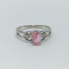 A Pink Tourmaline Ring crafted in 925 silver is not just a beautiful piece of jewelry but also holds special birthstone significance and healing properties. As the birthstone for October, Pink Tourmaline is believed to represent love, compassion, and emotional healing. This gemstone is said to enhance feelings of self-worth and strengthen emotional bonds. It's also associated with the heart chakra, promoting love and harmony in relationships. Healing properties attributed to Pink Tourmaline include its ability to soothe anxiety, reduce stress, and bring a sense of inner peace. It's believed to inspire trust, promote emotional balance, and encourage a sense of calm and positivity. Wearing this gemstone as a ring can act as a constant reminder of these qualities, making it not only a stylish Pink Tourmaline Ring Silver, Pink And Silver Engagement Ring, Silver Pink Sapphire Rings For Gift, Silver Pink Sapphire Ring As Gift, Pink Sterling Silver Rings With Accent Stones, Silver Tourmaline Promise Ring, Pink Topaz Center Stone Ring In Sterling Silver, Elegant Pink Tourmaline Birthstone Ring, Pink Topaz Ring With Accent Stones In Sterling Silver