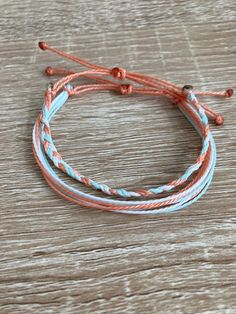 three bracelets on top of a wooden table