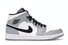 the air jordan 1 mid is available in grey and white, with black accents on the upper