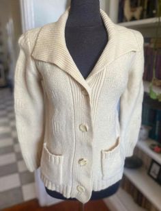 "Vintage 70s wool button up cardigan by Casual Corner. Buttons up the front, ivory cream in color and has pockets. 100% wool.  Great vintage condition. No stains or holes. MISSING MATCHING BELT. Could remove the belt loops or pair it with something unique for a pop of color! Size: tagged M. BEST FIT S. Always refer to measurements for more accurate sizing. Measurements taken laying flat: STS: 15\" PTP: 18\" SL: 16\" inseam L: 24.5\" ALL SALES ARE FINAL SO PLEASE DOUBLE CHECK THE MEASUREMENTS PRIOR TO BUYING AND DON'T HESITATE TO REACH OUT IF YOU HAVE ANY QUESTIONS!  All items are vintage/preloved and may have small imperfections. This should be expected for secondhand clothing. ALL MAJOR FLAWS WILL BE NOTED IN THE DESCRIPTION AND PHOTOGRAPHED." Miss Match, Wrap Jacket, Button Up Cardigan, White Sweaters, Second Hand Clothes, Vintage 70s, Vintage Black, Sweater Outfits, Beautiful Dresses