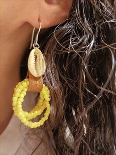 Handmade leather earrings, with cowries and seed beads. The sea is always my source of inspiration to create my jewelry, I collect shells myself during the summer, contact with nature is something that fascinates me There are two color options, black and yellow. Please note that due to lighting effects, monitor's brightness, contrast and other settings, there may be some slight differences in the color tone/shade of the photo. Please review our shop policies before purchasing. By purchasing Aleo Handmade Beaded Earrings For Beach, Unique Nickel-free Earrings For Beach, Bohemian Yellow Earrings For Beach, Handmade Beaded Drop Earrings For Vacation, Dangle Cowrie Shell Earrings For Beach, Handmade Cowrie Shell Earrings For Beach, Handmade Cowrie Shell Earrings For Vacation, Bohemian Cowrie Shell Earrings For Summer, Bohemian Adjustable Cowrie Shell Earrings