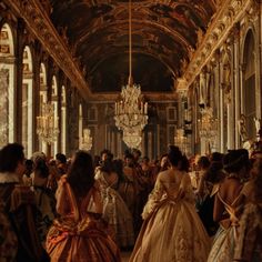 a group of people dressed in fancy clothing standing inside of a building with chandeliers hanging from the ceiling