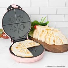 a panini maker sitting on top of a counter next to some sliced up cheese