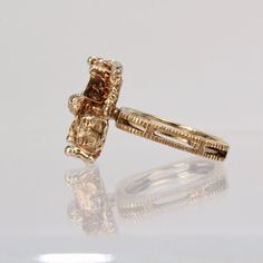 An exciting American Brutalist cocktail ring in 10K yellow gold.  The cast top rests on a square, textured split shank.   The interior of the shank is signed I. F. and marked for 10K gold fineness.  Simply a subtle, edgy statement ring!  Measurements: Width: ca. 11mm Length: ca. 17mm Height from shank: ca. 9mm  Ring Size: ca. 5 1/4  Weight: ca. 7.5 g Modernist 14k Gold Ring For Formal Occasions, Formal Modernist 14k Gold Ring, 14k Yellow Gold Square Cut Diamond Ring, Modernist Hallmarked Wedding Rings, Modernist Yellow Gold Rings For Formal Occasions, Unique 14k Gold Diamond Ring For Formal Occasions, Heirloom Nugget Rings As Gift, Modernist Gold Rectangular Signet Ring, Gold Rectangular Modernist Signet Ring