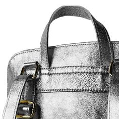 Looking for a versatile and stylish bag for everyday use? Look no further than this Pewter Convertible Metallic Leather Pocket Backpack, which can be worn as a backpack, over the shoulder, or carried by hand using the top handle. Crafted from pewter metallic leather, this backpack is both stylish and durable. Its interior is thoughtfully designed with separate compartments to keep your belongings organized and secure. The top of the backpack can be securely closed with a smooth-gliding zipper fo Metallic Rectangular Shoulder Bag For Travel, Leather Backpack With Silver-tone Hardware For Travel, Leather Travel Backpack With Silver-tone Hardware, Metallic Rectangular Travel Bag, Versatile Silver Bag For Daily Use, Modern Metallic Double Handle Bag, Metallic Satchel Shoulder Bag For Everyday Use, Travel Shoulder Bag With Silver-tone Hardware In Metallic, Silver Bags With Top Carry Handle For Daily Use