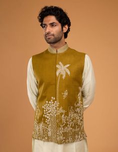 Editor's Note Elevate your ethnic wardrobe with this mehendi green nehru kurta featuring intricate embroidery. Paired with a soothing pista kurta and pants, this charming combination exudes traditional charm with a contemporary twist, making it a delightful choice for your special occasions. Fabric: Kurta: cotton silk, jacket: irish linen Color: Green Components: Kurta, jacket and pants Occasion: Festive Note: Product colour may slightly vary due to photographic lighting sources Care: Dry clean Cotton Nehru Jacket With Floral Embroidery, Cotton Nehru Jacket For Navratri Designer Wear, Cotton Nehru Jacket With Cutdana And Long Sleeves, Festive Cotton Bandhgala With Chikankari Embroidery, Festive Green Chanderi Bandhgala, Sleeveless Nehru Jacket With Resham Embroidery For Eid, Green Chanderi Nehru Jacket Straight Kurta, Green Chanderi Nehru Jacket In Straight Kurta Style, Designer Green Chanderi Nehru Jacket