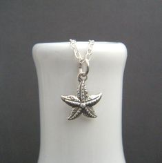 small starfish necklace. tiny sterling silver star fish ocean pendant. seastar. sea star. beach jewelry. realistic marine nature charm. 1/2" - A small sterling silver starfish, measuring just under 1/2" (12 mm) across, 1/2" (14 mm) down. - Necklace is 1.5 mm sterling silver cable chain, with high quality lobster clasp and locking jump rings, all solid sterling silver. Length customizable at drop down menu. - Design is oxidized (blackened) to bring out the details. - Back has small 925 mark and is hollowed out. - Packaged in a modern circular tin, ready for gift giving, and comes with a silver polish pad and care instructions. Customize chain length or "charm only" option: - Charm only option, no chain. Charm does include a top ring. - Chain length: Choose a set length from the drop down me Sterling Silver Starfish Charm Necklace, Star Beach, Ocean Pendant, Starfish Jewelry, Fish Ocean, Ocean Fishing, Starfish Necklace, Star Fish, Silver Polish