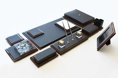 an assortment of black and gold objects are on display in front of a white background