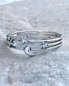 Moon and Stars Silver Ring | The Life Divine Moon and Stars Layered Cut Out Sterling Silver RingThe Moon is a feminine symbol and represents the light that shines within each of us. She reminds us that all things on earth have a natural cycle.The stars which light up the evening sky inspire us to dream. Sterling SilverRing measures 1/4". Feminine Symbols, Layered Cut, Evening Sky, Moon And Stars, Layered Cuts, Size 10 Rings, On Earth, Sterling Silver Ring, Light Up