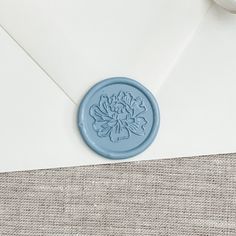 a blue wax stamp sitting on top of an envelope