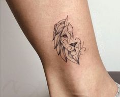 a woman's lower leg with a tattoo on it that has a lion head