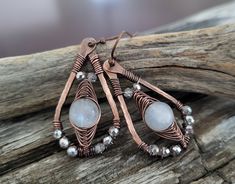 Moonstone Beaded Dangle Earrings -high quality handcrafted unique design with a bohemian feel -made of solid patina copper -featuring pretty natural iridescent moonstone with sparkly silver glass beads  -woven wire wrap detail -classic teardrop shape -lightweight and comfortable for everyday wear or that special occasion -great gift idea for the woman who loves artisan jewelry -copper plated brass ear hooks - nickel free, lead free and cadmium free Size:  1.75 inches long (measurement includes the ear hook) .75 inch wide. See more handmade artisan jewelry in my shop - main page: tfuniquetwists.etsy.com Wire Jewelry Making, Moonstone Beads, Beaded Dangle Earrings, Unique Gemstones, Beaded Dangles, Copper Jewelry, Boho Earrings, Wire Wrapped Jewelry, Metal Jewelry