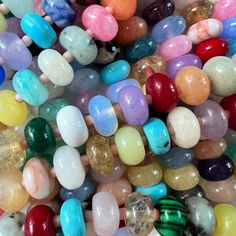 many different colored beads are stacked together