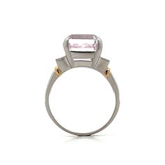 The star of this show is a stunning 9.64 carat emerald cut Kunzite. The soft pink hue of the center stone make it easy to accessorize. Adding to the glamour are six sparkling natural round brilliant cut diamonds, three on each side of the center stone. The platinum setting provides a polished backdrop for the Kunzite while and the 18 karat yellow gold accents on the shoulders add a touch of warmth to the overall design. Luxury Pink Diamond Ring For Formal Occasions, Elegant Gia Certified Pink Diamond Ring, Luxury Pink Platinum Rings, Elegant Pink Gia Certified Diamond Ring, Luxury Morganite Diamond Ring With Prong Setting, Fine Jewelry Pink Radiant Cut Rings, Luxury Pink Rings With Center Stone, Pink Luxury Rings With Center Stone, Elegant Pink Diamond Ring In Platinum