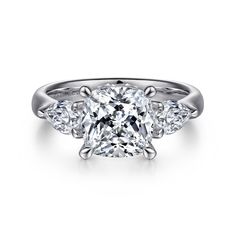 a cushion cut diamond ring with three side stones