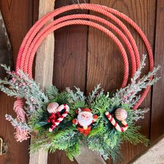 a christmas wreath with candy canes and greenery