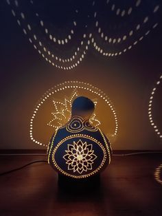 an illuminated vase sitting on top of a wooden table