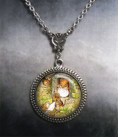 "Mouse Mom Beatrix Potter Art Nouveau necklace (Listing 97) Beatrix Potter's classic artwork with little mouse children carrying a candle. This adorable illustration has been preserved under glass and set into an Art Nouveau style necklace. It's a sweet gift for Mom, and also a unique piece for your favorite candle maker. The chain closes with a toggle clasp and lobster clasps are also available upon request at no extra charge. We have 5 lengths of chain to choose from at checkout (18\", 21\", 2 Themed Pendant Necklaces For Gifts, Themed Pendant Necklaces As A Gift, Themed Pendant Necklace As Gift, Themed Pendant Necklace For Gifts, Themed Necklace With Lobster Clasp As Gift, Themed Hand Painted Jewelry For Gifts, Vintage Hand Painted Necklace As Gift, Vintage Hand Painted Necklaces For Gift, Hand Painted Vintage Necklace As Gift