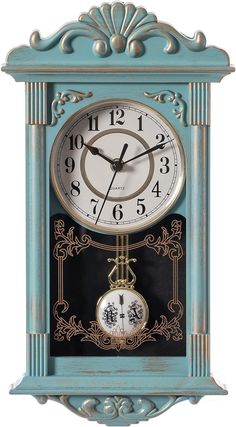 a blue clock with an ornate design on the face