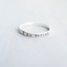 Skinny sterling silver ring that measures 2mm wide stamped with I am Worthy. Ring can come in sizes 4, 5, 6, 7, 8, 9, and 10. *Due to the process of hand stamping in each letter, the ring can stretch to be up to 1/2 size larger. Not sure of your ring size? Head over to this free printable to find your size. https://www.jewelry-secrets.com/Blog/wp-content/uploads/2015/05/Ring-Size-Chart1.pdf All Simpli Stamped jewelry comes ready to gift, packaged in a charming kraft box, tied with a coordinating Meaningful Silver Stackable Rings, Meaningful Sterling Silver Engraved Ring, Meaningful Stackable Sterling Silver Rings, Meaningful Engraved Sterling Silver Promise Ring, Meaningful Sterling Silver Promise Ring Engraved, Meaningful Stackable Engraved Sterling Silver Ring, Meaningful Engraved Sterling Silver Stackable Ring, Meaningful Sterling Silver Stackable Engraved Ring, Meaningful Stackable Sterling Silver Jewelry