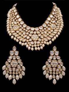 Nia Jadau Polki Set A gold tone chunky Polki Jadau Necklace Set with big Kundan stones. This set comes with beautiful matching jhumkis/earrings. Can be worn with a statement long necklace for a bridal jpiece. Approximate earrings length is 3.5". Gold-plated on high-quality brass as base metal. SET INCLUDES : Necklace & Earrings*Tikka can be added to this set Details: Handcrafted Metal: Gold Plated, Metal Alloy Stone: Kundan & Pearls Closure: Post for Pierced Ears DELIVERY:• Ready To Ship Traditional White Designer Jewelry, Festive Gold Designer Jewelry Sets, Gold Meenakari Temple Necklace For Designer Wear, Elegant Heavy Jewelry For Designer Wear, Elegant Heavy Designer Jewelry, Gold Necklace With Intricate Design For Designer Wear, Designer Gold Necklace With Intricate Design, Designer Wear Chandbali Jewelry With Intricate Design, Traditional Gold Jewelry Sets For Designer Wear