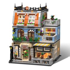 a building made out of legos is shown in this image, it has many windows and plants on the roof