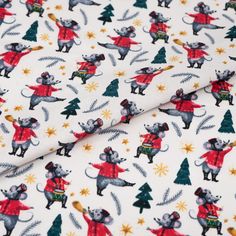 a white fabric with mice and christmas trees on it's side, as well as stars