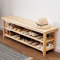 a wooden shoe rack with shoes on it and a hat sitting on top of it