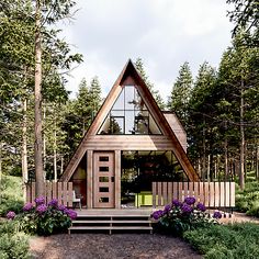 a small wooden cabin in the woods with purple flowers and trees around it's perimeter