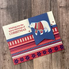 a christmas card with an image of a polar bear wearing a sweater on top of it