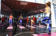 a group of women are doing yoga outside