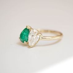 One lab created a pear-shaped diamond weighing approx. 1.00 ctw, D or E color VS clarity. One natural pear-shaped emerald diamond weighing approx. 1.00 ctw, AAA quality. The band is 1.85mm wide and half round. Berlinger Jewelry, Emerald Set, Shiny Objects, Antique Stone, Gem Ring, Pear Shaped Diamond, 14k White Gold Ring, Princess Cut Diamonds, Emerald Diamond