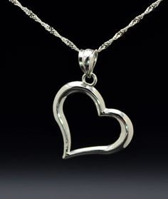 The Varenna Ladies Contemporary 14K White Gold Heart Necklace. Dangling from a 16 inch chain is a 0.75 inch white gold heart pendant. The perfect gift for that special someone. Each piece has been hand selected and meticulously identified and graded by a Graduate Gemologist who has been awarded a degree by the Gemological Institute of America (GIA). Please visit our Shop's About Page or our website for more information about our jewelry. Sizing for all rings is an additional charge and will be d Classic Heart-shaped Sterling Silver Necklace, Classic White Gold Jewelry With Heart Charm, Formal Heart Charm Jewelry With Heart Pendant, Formal Heart Pendant Jewelry With Heart Charm, Classic Open Heart Jewelry For Valentine's Day, Classic Jewelry With Heart Charm And Heart Cut, Sterling Silver Formal Jewelry For Valentine's Day, Classic Polished Heart Pendant Jewelry, Sterling Silver Jewelry For Valentine's Day Formal