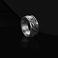 a wedding ring with an intricate design on the inside of it, against a black background