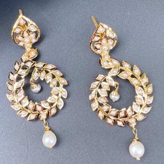 Featuring a pair of jadau earrings that are perfect for any occasion. Made in 22ct gold and embellished with finest freshwater pearls. These unique earrings feature the perfect balance of contemporary style and timeless elegance, making them the perfect gift or sentiment for any special occasion. The earrings weigh 12.04 GMs including 0.57 GMs of hanging pearl drops Elegant Chandbali Pearl Earrings For Festive Occasions, Elegant White Hoop Earrings For Festive Occasions, Elegant Kundan Chandelier Earrings, Elegant Round Kundan Danglers, Elegant Kundan Danglers, Elegant Pearl Drop Hoop Earrings For Festive Occasions, Elegant Round Chandbalis For Formal Occasions, Elegant Chandbali Hoop Earrings With Pearl Drop, Elegant Kundan Chandbalis With Pearl Drop