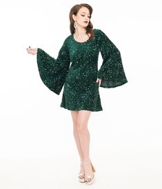 This flirtatious 1960s inspired piece is crafted in green stretch knit fabric that dances with dazzling green sequins throughout. The wide scoop neckline is framed by jaw-dropping long angel sleeves. Complete with a back zipper and side pockets!.Available in sizes XS-4X while supplies last. | Smak Parlour 1960S Green Sequin Downtown Scene Mini Dress | Size Xsmall/2 Mini Dress Unique, 1960s Inspired, Angel Sleeves, Outfit Wedding Guest, Dress Unique, Angel Sleeve, Green Sequins, Comfortable Dress, Short Skirt