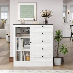 a white cabinet with drawers in a living room