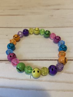 This smiley face beaded bracelet would make a cute gift for a teen or women's Birthday. They would make a great gift for Mother's Day.  It has blue, yellow, purple, orange, and green smiley face beads. It has blue, yellow, purple, orange, and green 8mm faceted beads. It was made with .8mm sturdy stretch string. I tie it several times to prevent breakage.  It fits most women and teens. It stretches to fit on the wrist. All items are ready to be shipped I do combined shipping. Items ship in 2-5 business days. Check out more items at: http://www.etsy.com/shop/MesheleCrafts  https://www.facebook.com Casual Charm Bracelet With Round Beads For Friendship, Cheerful Multicolor Adjustable Jewelry, Casual Friendship Charm Bracelet With Round Beads, Fun Beaded Bracelets With Round Beads, Fun Colorful Beads Bracelets For Everyday, Everyday Cute Stretch Bracelet With Colorful Beads, Casual Adjustable Beaded Bracelets For Birthday, Playful Beaded Stretch Bracelet, Adjustable Beaded Fun Jewelry